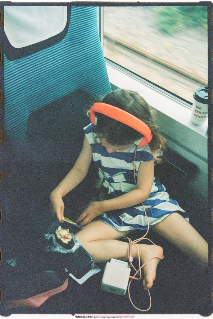 The best travel toy is the Yoto Player, here seen on a girl in a train 