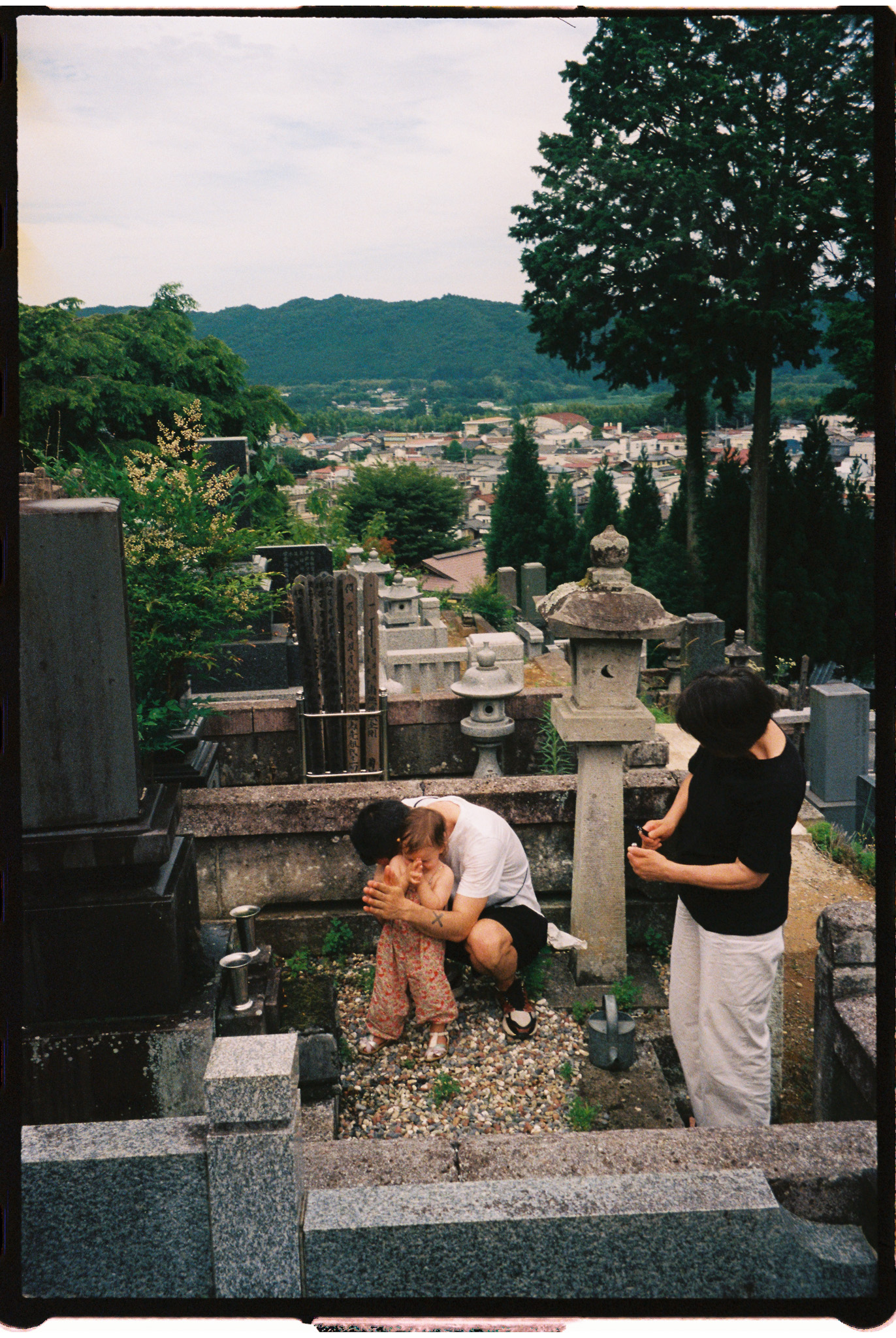 Japan with family, a family praying at a local graveyard 